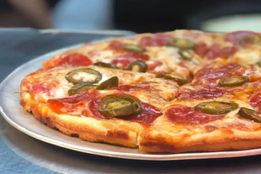 Pepperoni pizza served at Brick Oven Clemmons on a metal tray