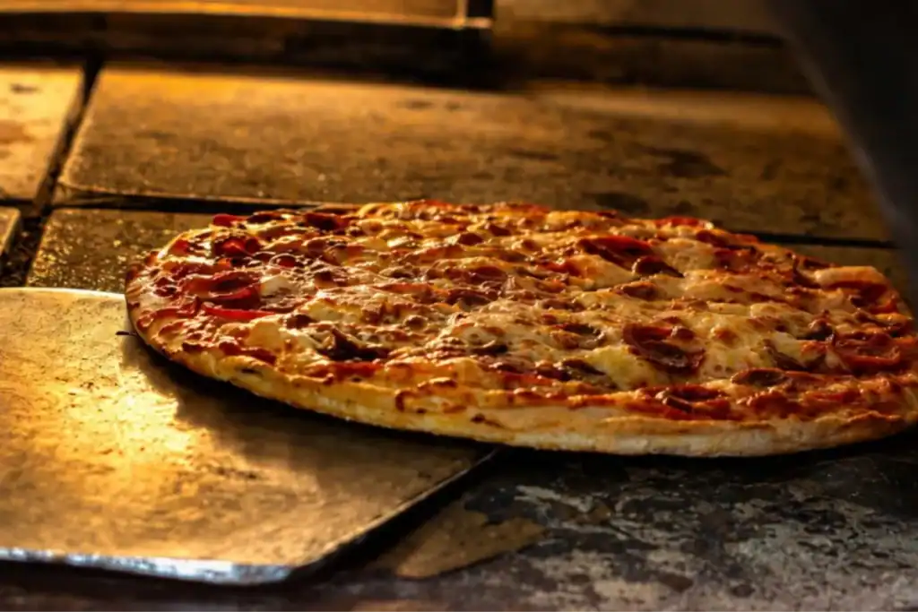 Brick Oven Clemmons pizza fresh from the oven with melted cheese and toppings